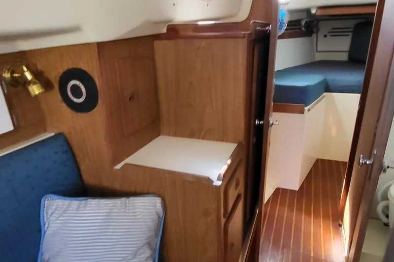Slide: The Image of Interior of 1979 Pearson 365 Sloop, featuring cozy cabin with wood paneling and seating. - 34