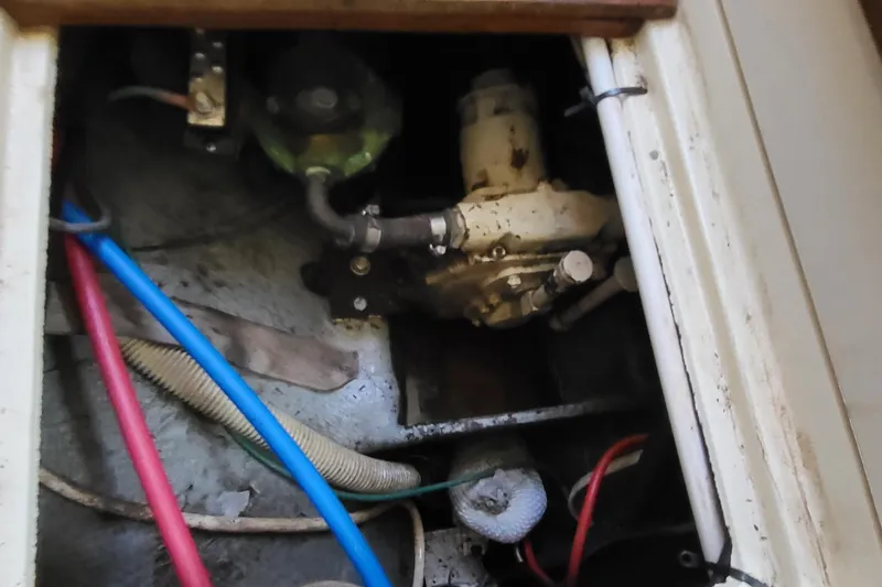 Slide: The Image of Engine compartment of a 1979 Pearson 365 Sloop with visible hoses and components. - 35