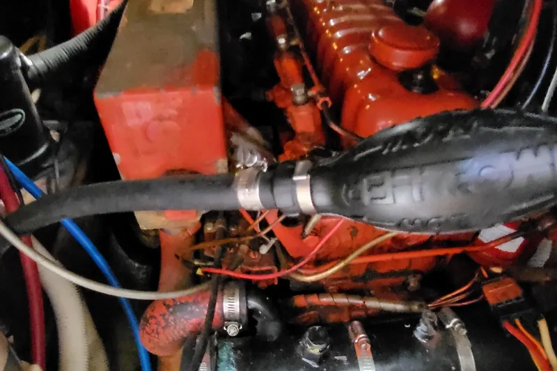 Slide: The Image of Engine of a 1979 Pearson 365 Sloop sailboat, featuring red components and wiring. - 36