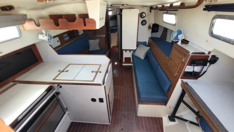 Slide: The Image of Interior of 1979 Pearson 365 Sloop sailboat with cozy seating and compact kitchen. - 17
