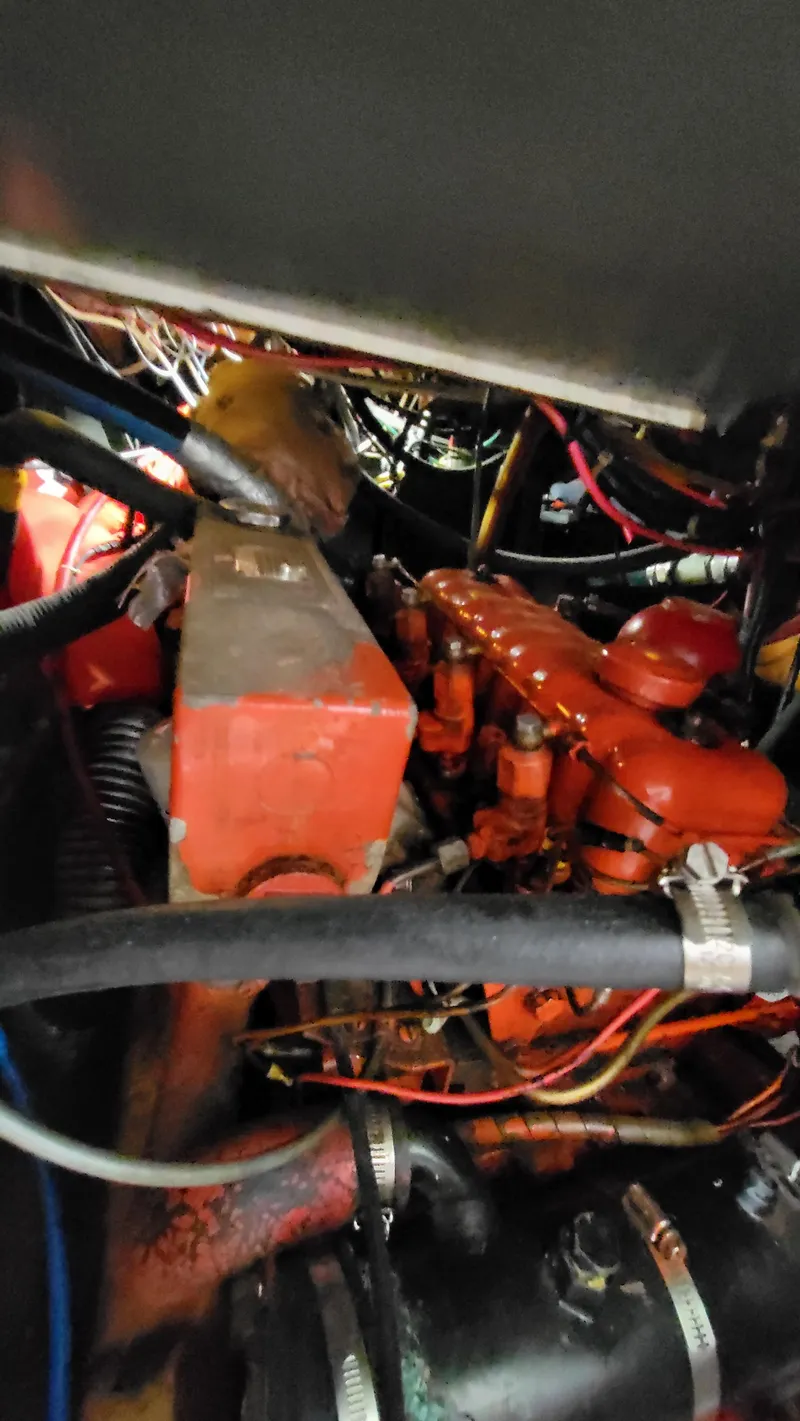 Slide: The Image of Engine compartment of a 1979 Pearson 365 Sloop with visible red engine components. - 25