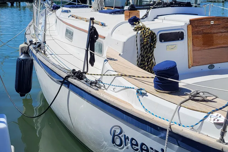 Slide: The Image of 1979 Pearson 365 Sloop sailboat docked in marina, named "Breezy." - 3