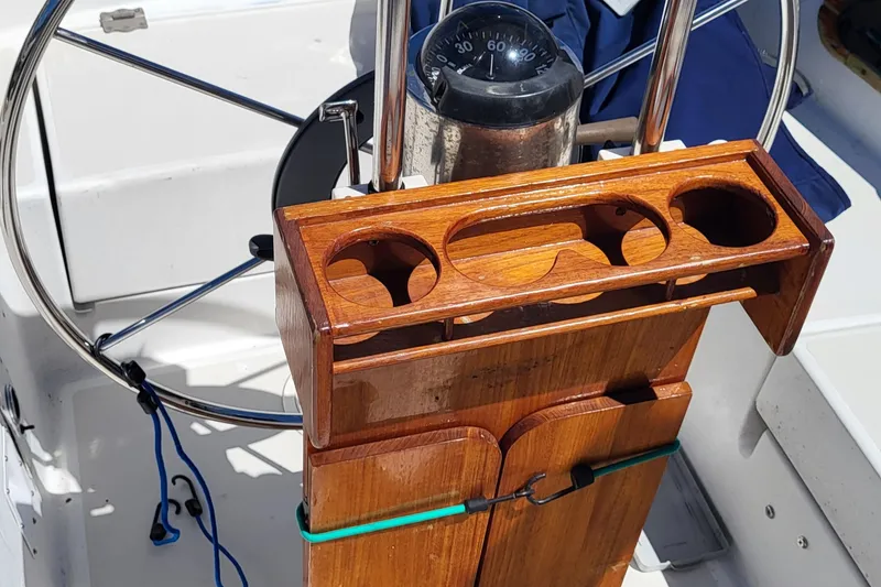 Slide: The Image of Wooden helm station on 1979 Pearson 365 Sloop with compass and cup holders. - 31