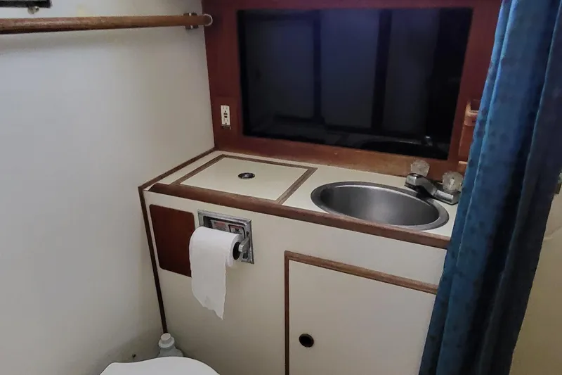 Slide: The Image of 1979 Pearson 365 Sloop bathroom with sink, toilet, and window. - 32