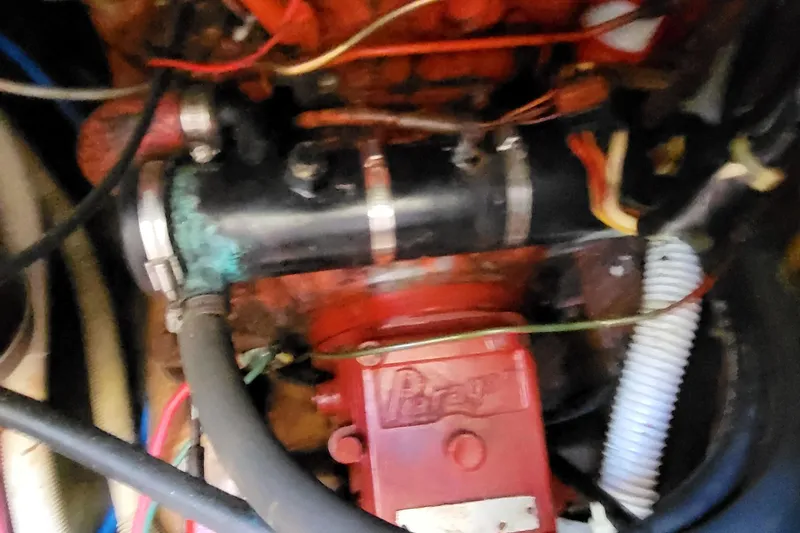 Slide: The Image of Engine compartment of a 1979 Pearson 365 Sloop sailboat, showing mechanical components and wiring. - 40