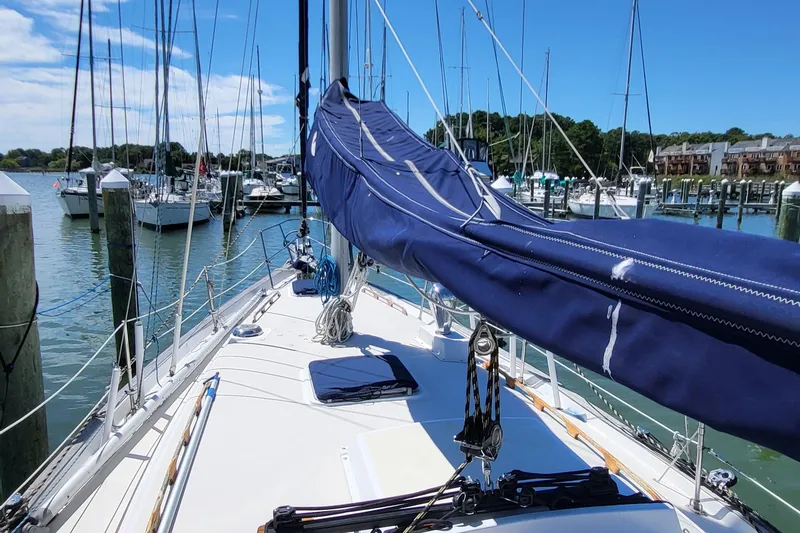Slide: The Image of 1979 Pearson 365 Sloop sailboat docked in a sunny marina. - 7