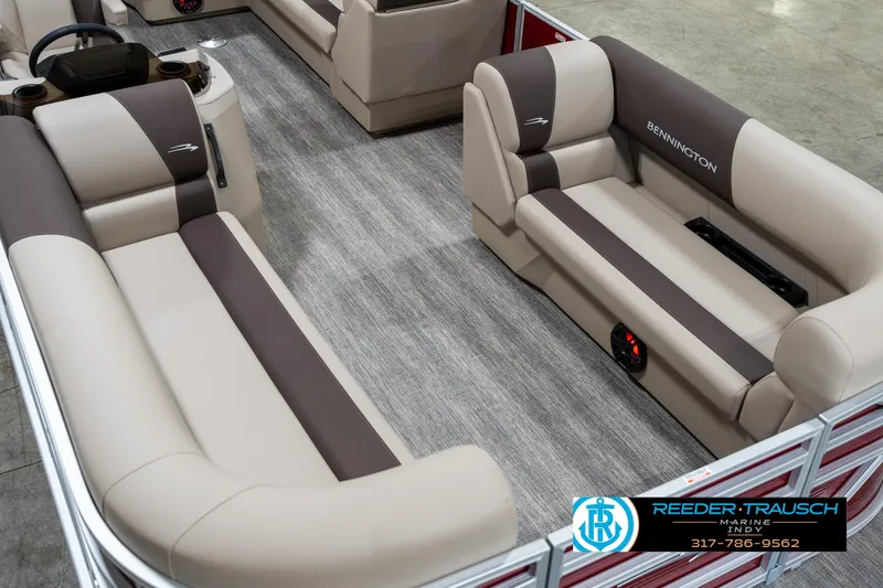 Slide: The Image of 2025 Bennington 21 SLS pontoon boat interior with beige and brown seating. - 10