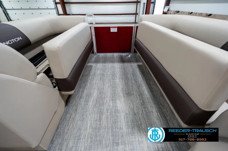 Slide: The Image of 2025 Bennington 21 SLS boat interior with beige seating and gray flooring. - 18