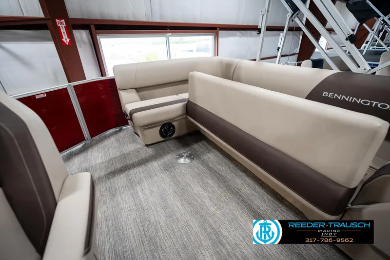 Slide: The Image of 2025 Bennington 21 SLS boat interior with beige seating and carpeted floor. - 22