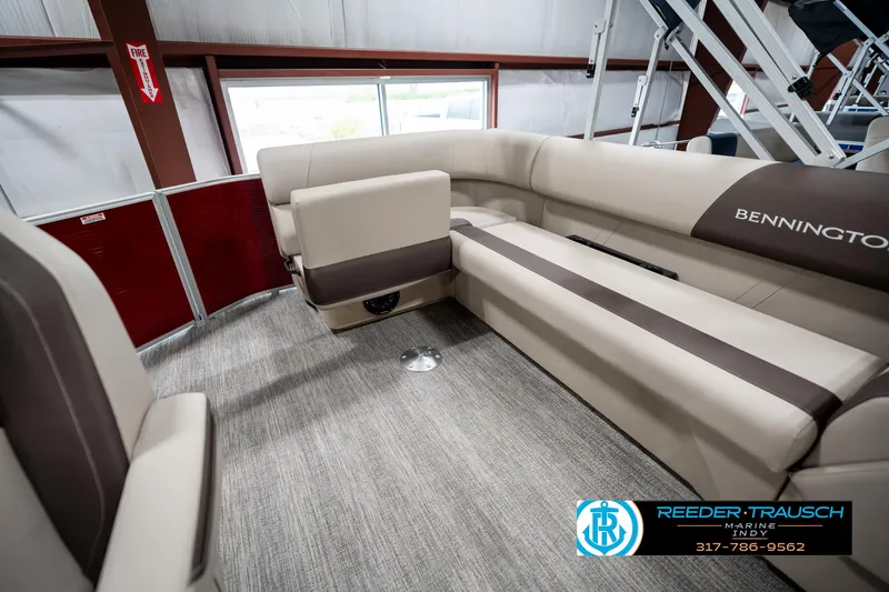 Slide: The Image of 2025 Bennington 21 SLS boat interior with beige seating and carpet flooring. - 23