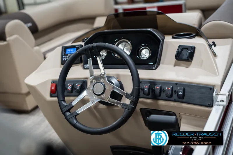 Slide: The Image of 2025 Bennington 21 SLS boat dashboard with steering wheel and controls. - 27