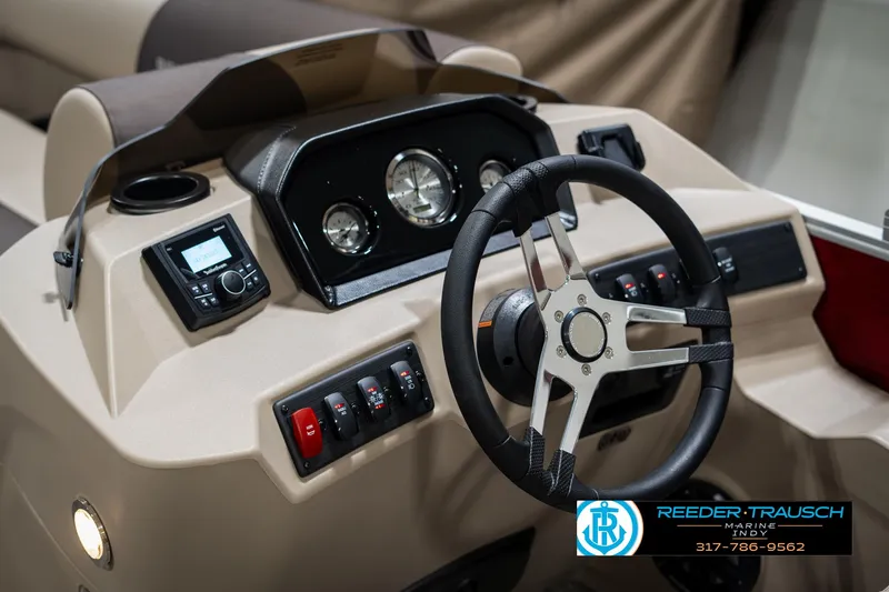 Slide: The Image of 2025 Bennington 21 SLS boat dashboard with steering wheel and control panel. - 28