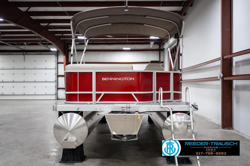 Slide: The Image of 2025 Bennington 21 SLS pontoon boat in a warehouse setting. - 6