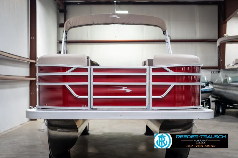 Slide: The Image of 2025 Bennington 21 SLS pontoon boat in a showroom, front view. - 7