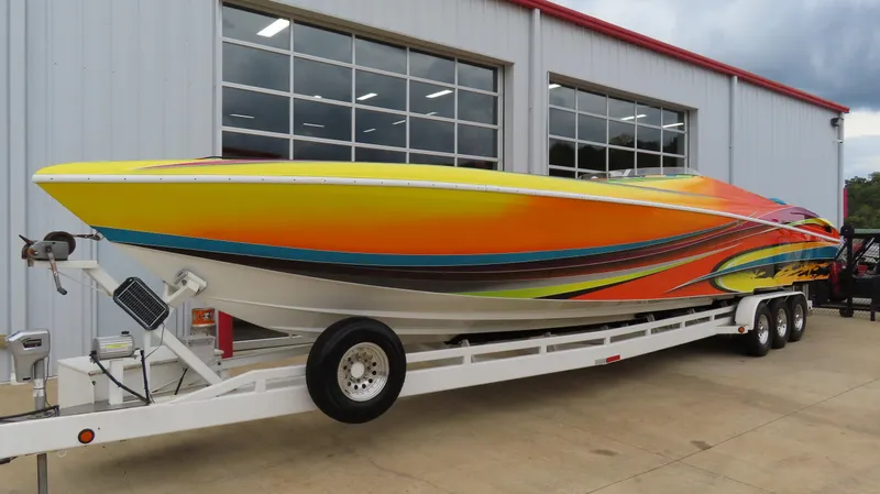 Slide: The Image of 2001 Outerlimits 42 Legacy speedboat with vibrant, colorful design on trailer. - 1