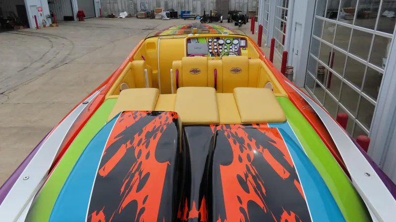 Slide: The Image of 2001 Outerlimits 42 Legacy speedboat with vibrant, colorful design and detailed dashboard. - 10