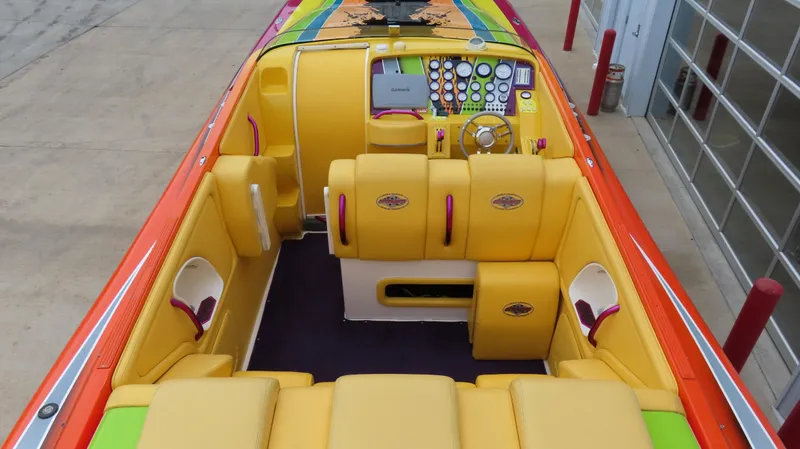 Slide: The Image of 2001 Outerlimits 42 Legacy boat with vibrant yellow and orange interior design. - 11