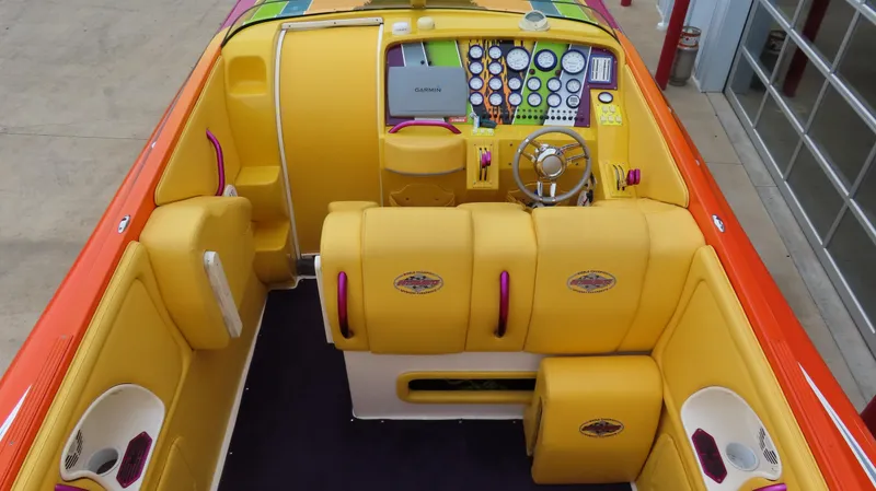 Slide: The Image of 2001 Outerlimits 42 Legacy boat interior with vibrant yellow and orange seating and dashboard. - 12