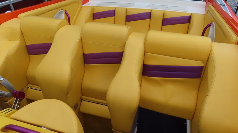 Slide: The Image of Yellow and purple interior seating of a 2001 Outerlimits 42 Legacy boat. - 16