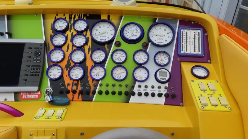 Slide: The Image of Colorful dashboard of a 2001 Outerlimits 42 Legacy boat with multiple gauges and controls. - 17