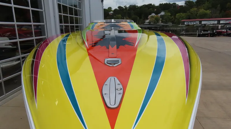 Slide: The Image of 2001 Outerlimits 42 Legacy boat with vibrant yellow, red, and blue design. - 2