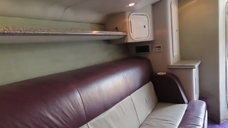 Slide: The Image of Interior of a 2001 Outerlimits 42 Legacy boat with leather seating and storage compartments. - 20