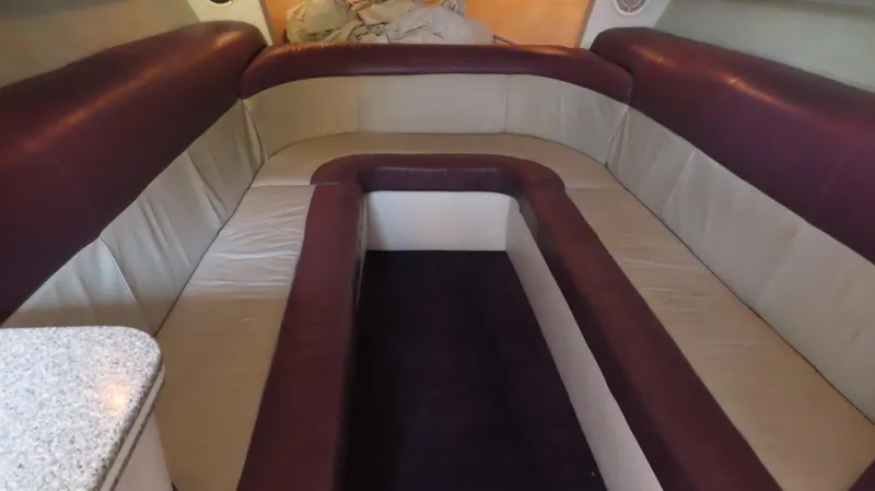 Slide: The Image of Interior seating of 2001 Outerlimits 42 Legacy boat, featuring maroon and beige upholstery. - 23