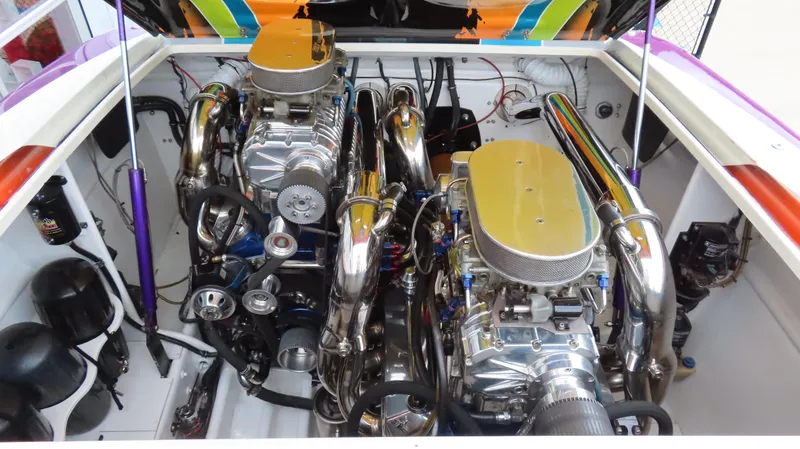 Slide: The Image of Engine compartment of a 2001 Outerlimits 42 Legacy boat, showcasing dual high-performance engines. - 26
