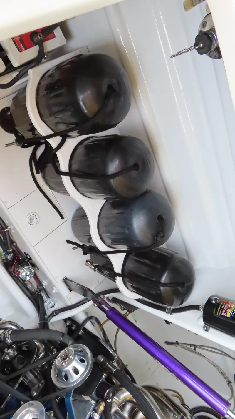 Slide: The Image of Engine compartment of a 2001 Outerlimits 42 Legacy boat with black fuel tanks. - 27