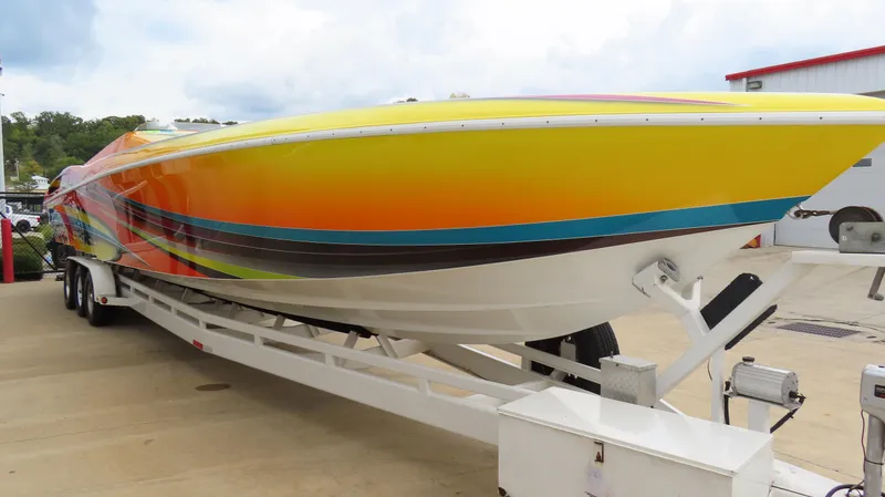 Slide: The Image of 2001 Outerlimits 42 Legacy speedboat with vibrant, colorful design on a trailer. - 3