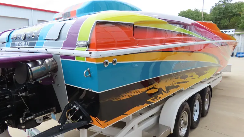 Slide: The Image of Colorful 2001 Outerlimits 42 Legacy speedboat on trailer, showcasing vibrant custom paint design. - 6