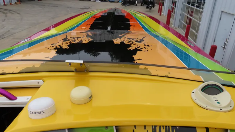 Slide: The Image of Colorful 2001 Outerlimits 42 Legacy boat with vibrant paint design and Garmin equipment. - 9