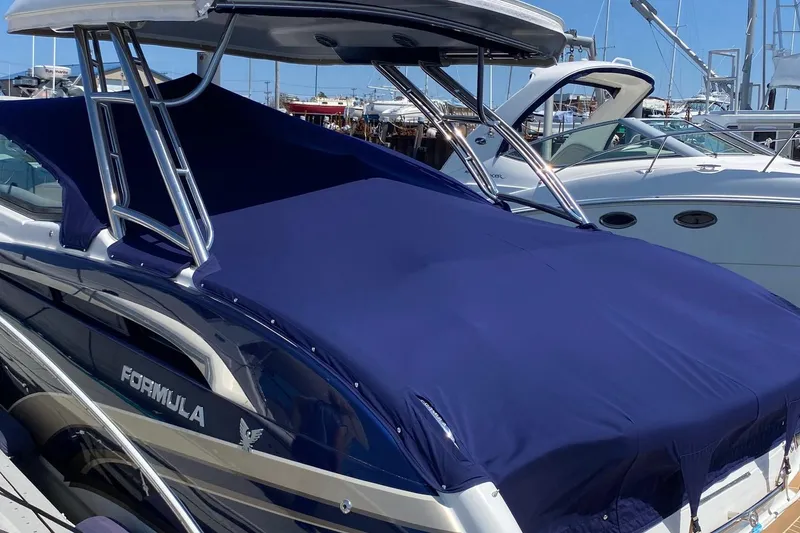Slide: The Image of 2016 Formula 350 Sun Sport boat with blue cover docked at marina. - 10