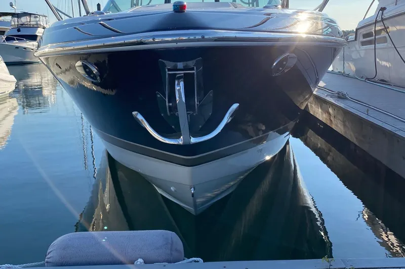 Slide: The Image of 2016 Formula 350 Sun Sport boat docked in marina, reflecting on water. - 11