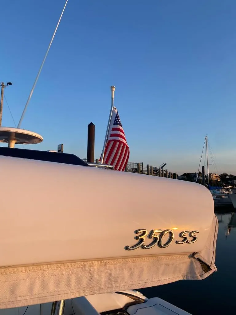 Slide: The Image of 2016 Formula 350 Sun Sport boat with American flag at sunset. - 15