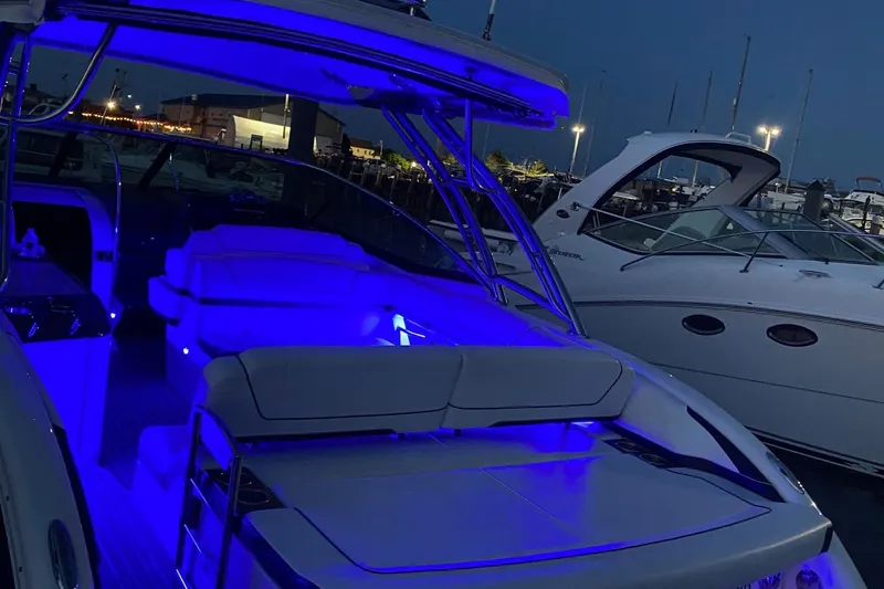 Slide: The Image of 2016 Formula 350 Sun Sport boat with blue interior lighting at night. - 16
