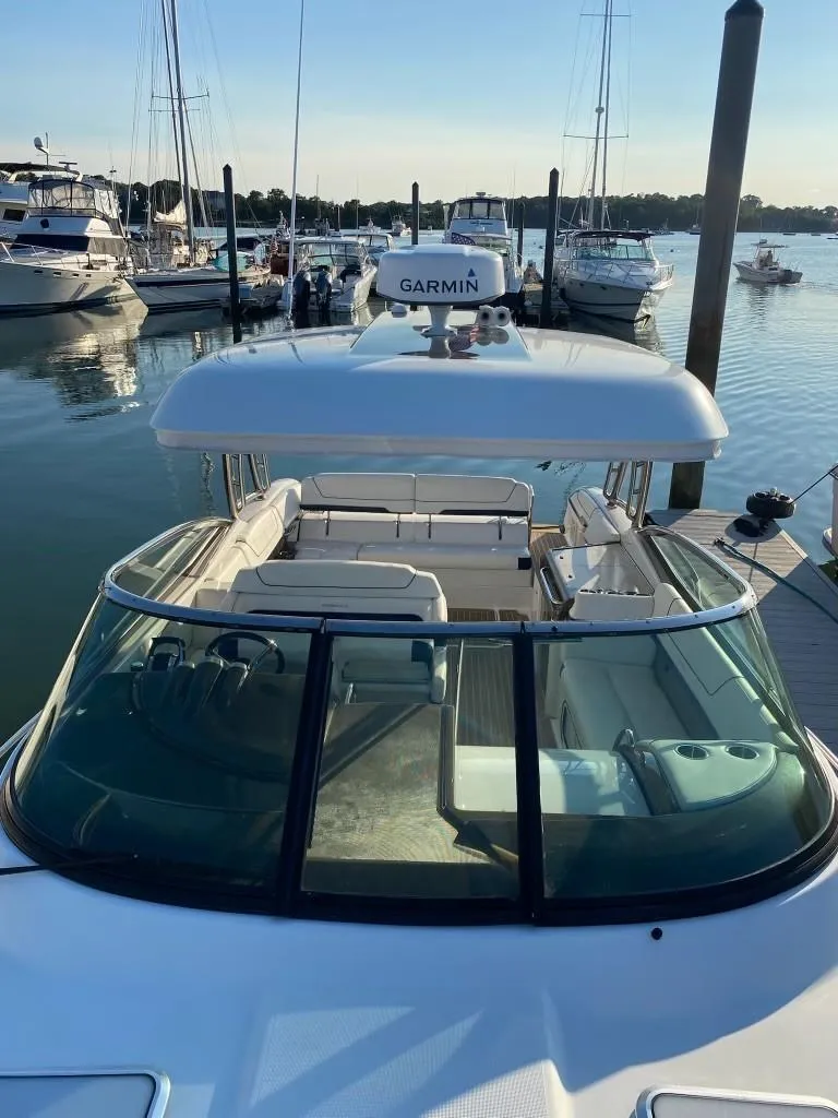 Slide: The Image of 2016 Formula 350 Sun Sport boat docked in marina, featuring Garmin equipment. - 17