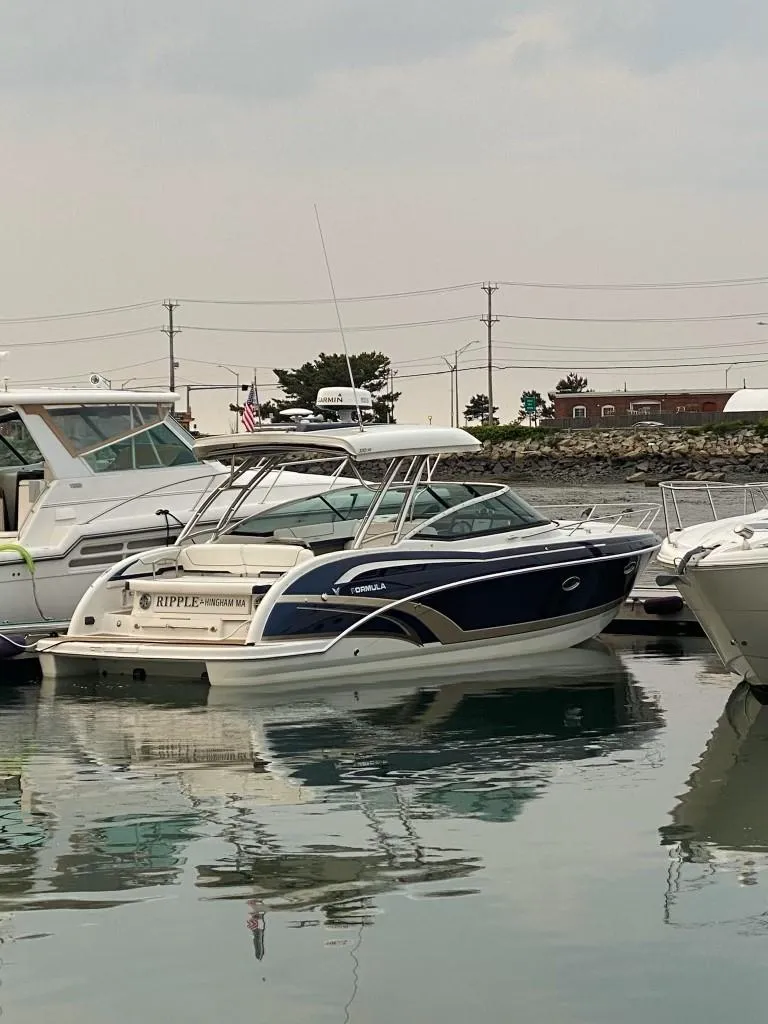 Slide: The Image of 2016 Formula 350 Sun Sport boat docked in a marina. - 2