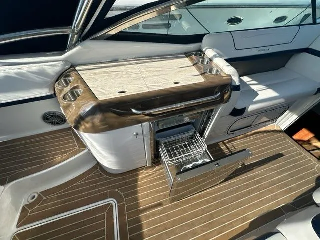 Slide: The Image of 2016 Formula 350 Sun Sport boat interior with wooden flooring and built-in storage. - 27