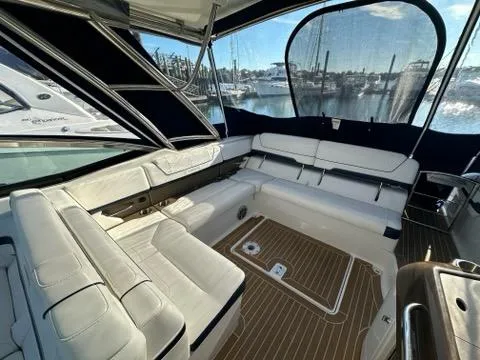 Slide: The Image of 2016 Formula 350 Sun Sport boat interior with white seating and wood flooring. - 29