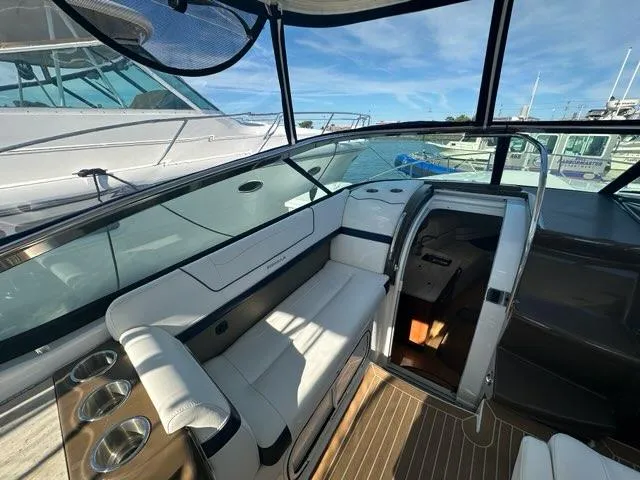 Slide: The Image of 2016 Formula 350 Sun Sport boat interior with seating and open cabin door. - 30