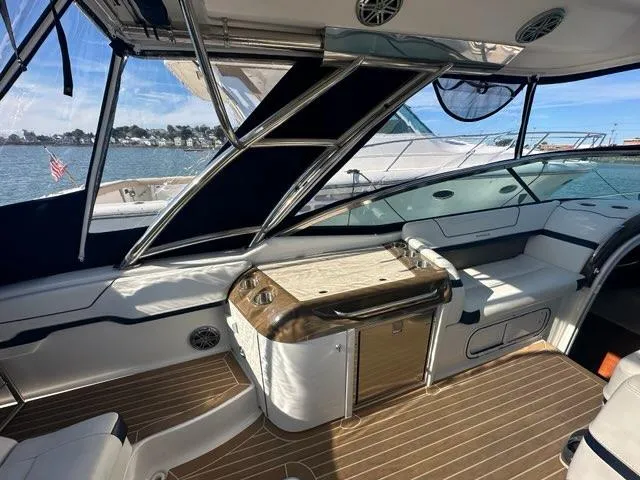Slide: The Image of 2016 Formula 350 Sun Sport boat interior with seating and wooden flooring. - 32