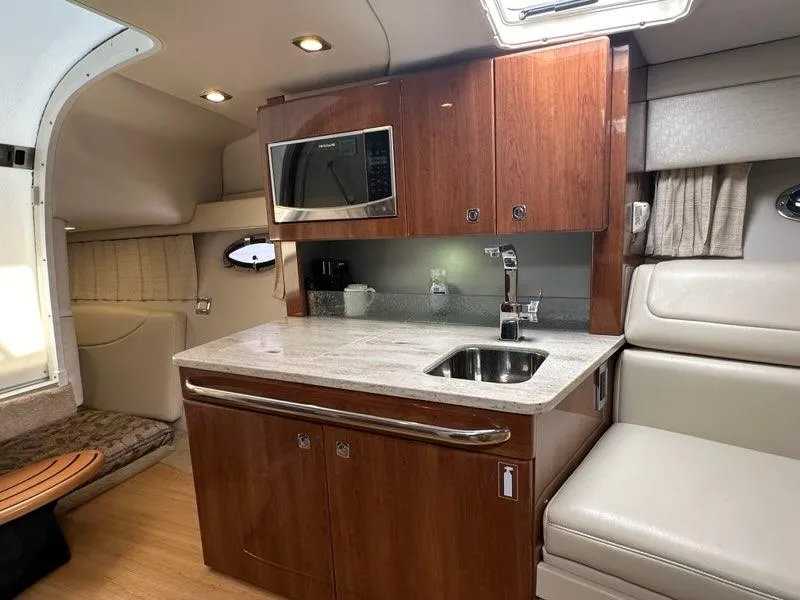 Slide: The Image of Interior of 2016 Formula 350 Sun Sport boat with kitchenette and seating area. - 47