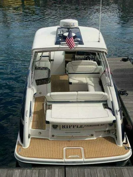 Slide: The Image of 2016 Formula 350 Sun Sport boat docked, featuring spacious seating and American flag. - 9