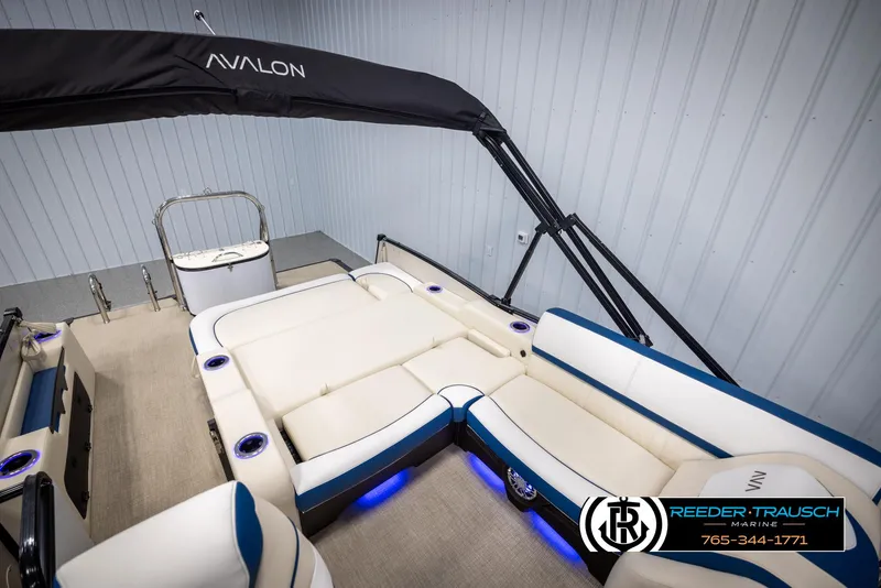 Slide: The Image of 2025 Avalon Catalina VRB boat interior with plush seating and ambient lighting. - 23