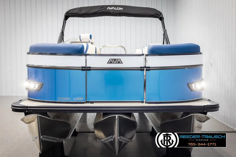 Slide: The Image of 2025 Avalon Catalina VRB pontoon boat with blue exterior, displayed indoors at Reeder Trausch Marine. - 8