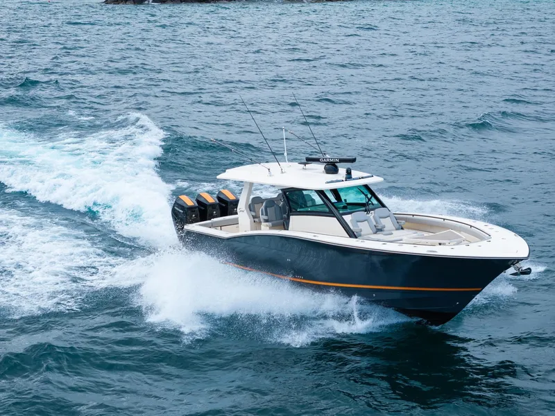 The Image of 2023 Scout 425 LXF boat cruising on open water, showcasing sleek design and powerful engines. - 0