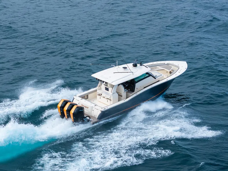 Slide: The Image of 2023 Scout 425 LXF boat cruising on open water, showcasing powerful engines. - 11