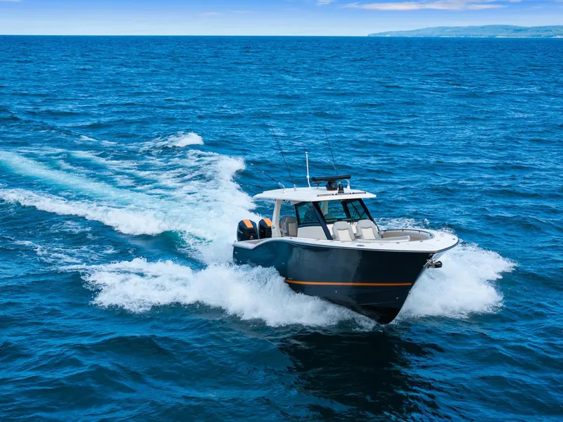 Slide: The Image of 2023 Scout 425 LXF boat cruising on open ocean waters. - 13