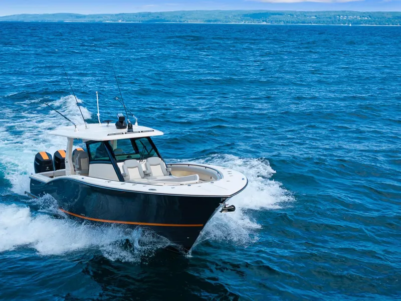 Slide: The Image of 2023 Scout 425 LXF boat cruising on open blue ocean waters. - 14